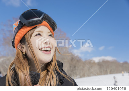 Snowboard girls standing with a smile at a snowy ski resort Snowboard girls standing with a smile at a snowy ski resort 120401056