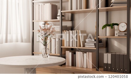 A round marble table features a flower vase in a contemporary room with a large bookshelf. 120401058