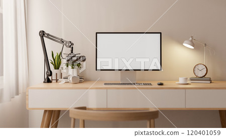 A cozy, minimalist home office featuring podcast equipment, a computer with a white screen mockup. 120401059