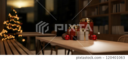 A close-up of elegant Christmas gift boxes placed on a wooden table in a cozy room at night. 120401063