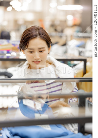 Apparel product A woman neatly folding her clothes 120401113