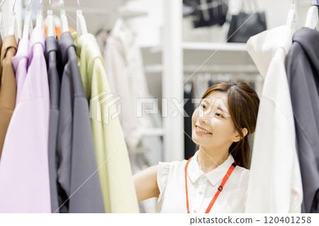 Woman working at an apparel store Woman working at an apparel store 120401258
