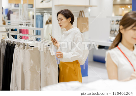 Woman enjoying shopping at an apparel store 120401264