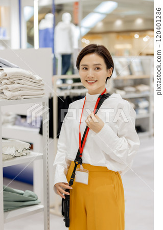 Woman working at an apparel store Woman working at an apparel store 120401286