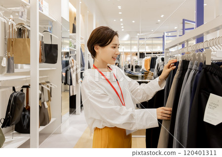Woman working at an apparel store Woman working at an apparel store 120401311