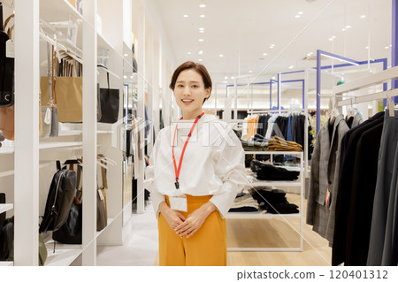Woman working at an apparel store 120401312