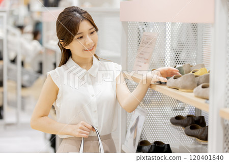 Woman enjoying shopping in a boutique 120401840