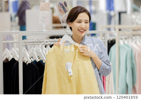 Woman enjoying shopping in a boutique 120401859