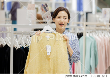 Woman enjoying shopping in a boutique Woman enjoying shopping in a boutique 120401861