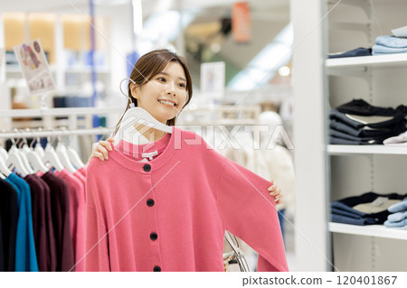Woman enjoying shopping in a boutique Woman enjoying shopping in a boutique 120401867