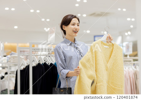 Woman enjoying shopping in a boutique Woman enjoying shopping in a boutique 120401874