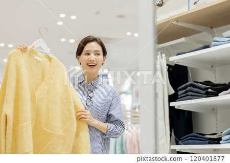 Woman enjoying shopping in a boutique Woman enjoying shopping in a boutique 120401877