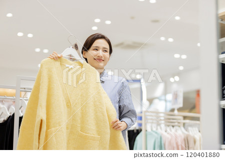 Woman enjoying shopping in a boutique 120401880