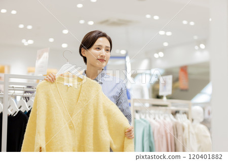 Woman enjoying shopping in a boutique Woman enjoying shopping in a boutique 120401882