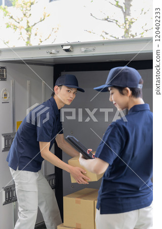 Deliveryman who puts (unloads) luggage on the truck Deliveryman who puts (unloads) luggage on the truck 120402233