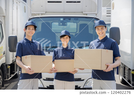 Image of logistics / transportation industry Men and women lined up in front of trucks 120402276