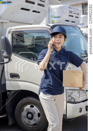 Logistics / transportation industry: A woman who contacts with a smartphone 120402282
