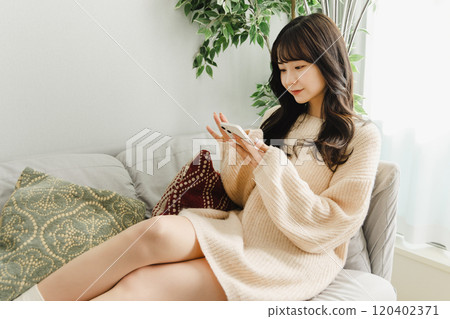 Woman relaxing on the sofa Woman relaxing on the sofa 120402371