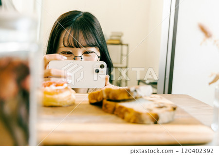 Young woman taking glorious photos Young woman taking glorious photos 120402392