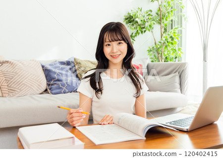 Young woman studying to get a qualification 120402415