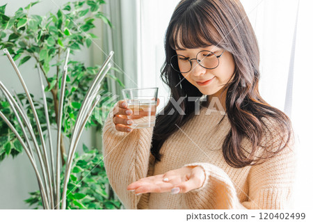 Woman taking medicine 120402499