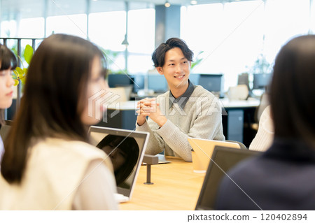 Men and women having a meeting using a monitor Men and women having a meeting using a monitor 120402894