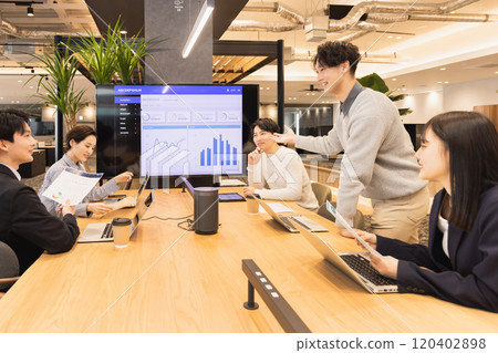 Men and women having a meeting using a monitor Men and women having a meeting using a monitor 120402898
