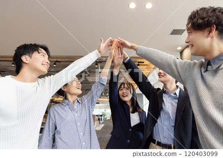 A circle of people working in a fashionable designer's office 120403099