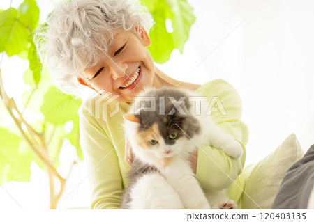 Senior Japanese woman holding a cat 120403135
