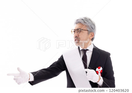 Gray-haired election candidate giving a speech on the street 120403620