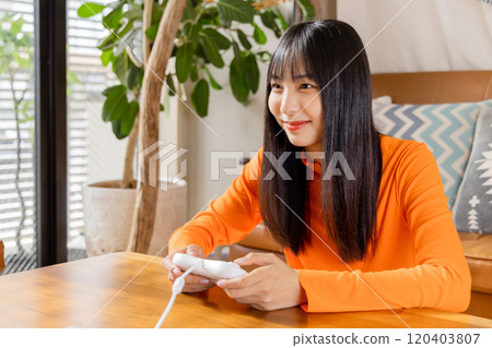 Young woman enjoying video games Home time 120403807