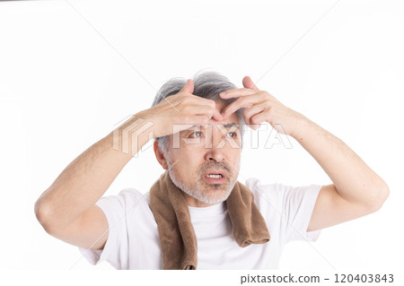 Middle-aged man taking care of his eyebrows Middle-aged man taking care of his eyebrows 120403843