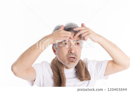 Middle-aged man taking care of his eyebrows Middle-aged man taking care of his eyebrows 120403844