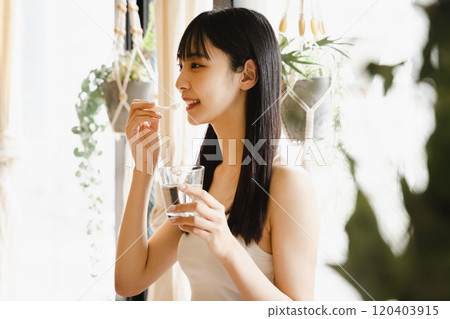 Young woman brushing her teeth whitening dressing 120403915