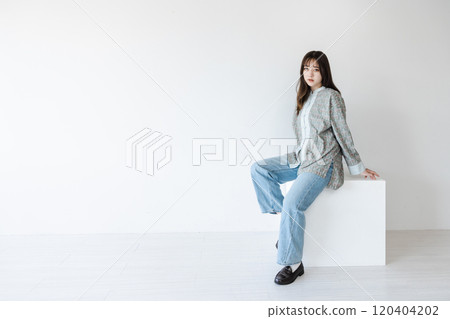 Half woman sitting on a white block Half woman sitting on a white block 120404202