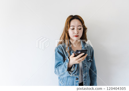 A young woman using a smartphone 120404305