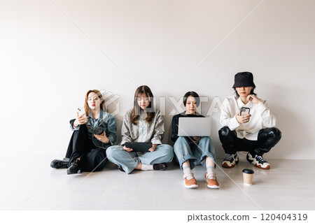 Generation Z men and women using smartphones, laptops, tablets (gadgets) Generation Z men and women using smartphones, laptops, tablets (gadgets) 120404319