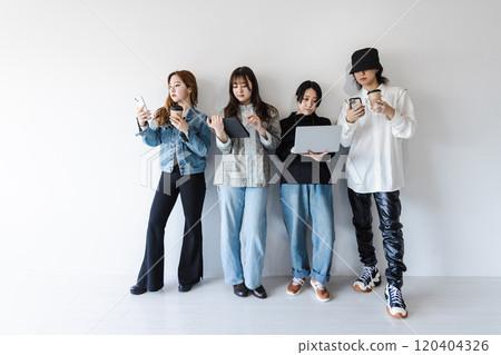 Generation Z men and women using smartphones, laptops, tablets (gadgets) 120404326