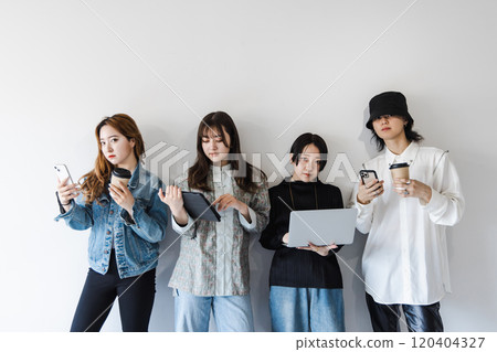 Generation Z men and women using smartphones, laptops, tablets (gadgets) Generation Z men and women using smartphones, laptops, tablets (gadgets) 120404327