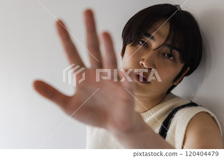 A young man trying to empty ●● from between his fingers A young man trying to empty ●● from between his fingers 120404479