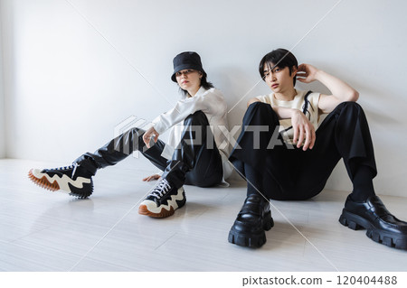 Fashionable man sitting on the white floor 120404488