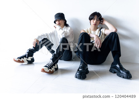 Fashionable man sitting on the white floor 120404489