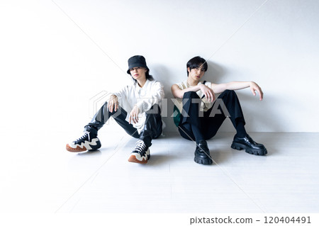 Fashionable man sitting on the white floor Fashionable man sitting on the white floor 120404491
