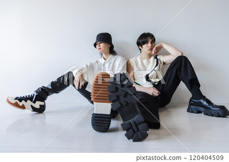 Fashionable man sitting on the white floor 120404509