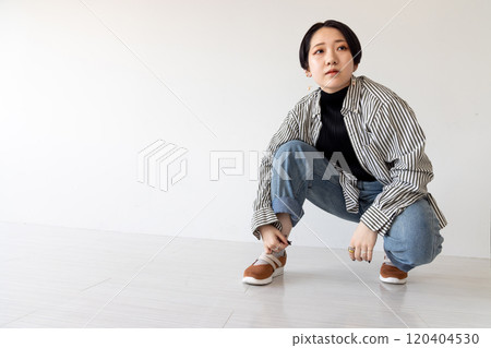 young woman squatting 120404530