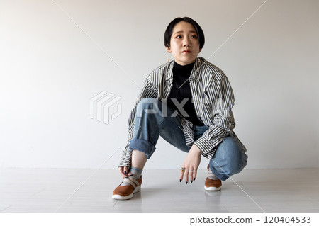 young woman squatting 120404533