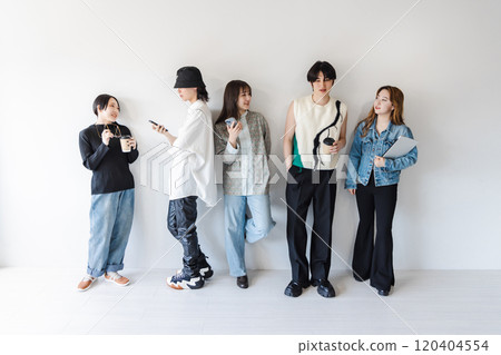 Generation Z men and women using smartphones and laptops Generation Z men and women using smartphones and laptops 120404554