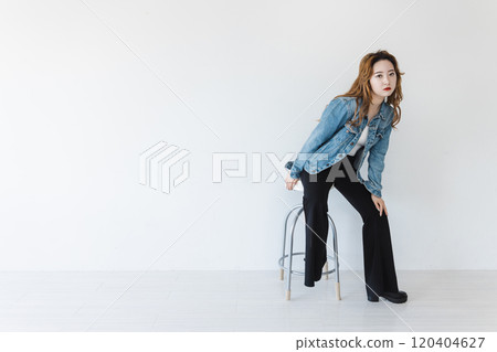 A bizarre woman sitting on a chair, brown hair, flared leg pants A bizarre woman sitting on a chair, brown hair, flared leg pants 120404627