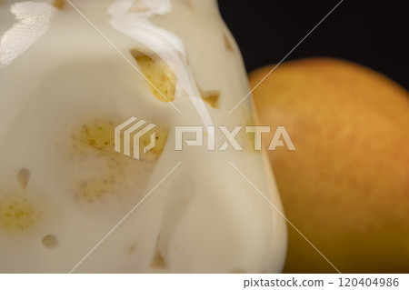 pear yogurt with pieces of fruit on the table pear yogurt with pieces of fruit on the table 120404986