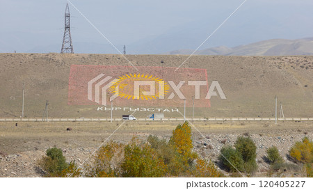 the flag of Kyrgyzstan on the hill, built by stone and sand 120405227